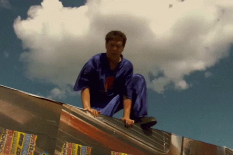 Idiocracy Guy Jumping And Swinging Wrecking Ball GIF