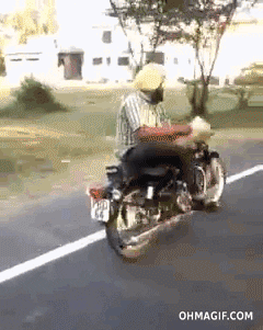 Indian Reading Book In Motorcycle GIF