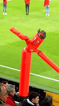 Inflatable Tube Man Waving In Sports Arena GIF