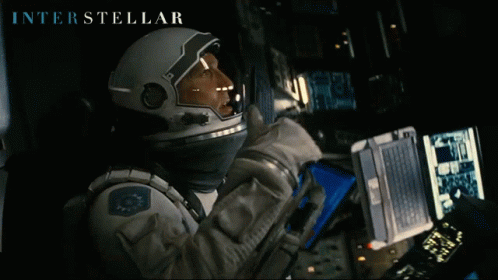 Interstellar Astronaut Looking At Laptop GIF