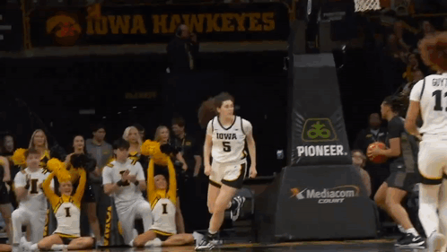 Iowa Hawkeyes Playing Basketball in Front of Crowd