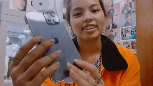 Happy Lady Showing Off Iphone 14 Pro GIF