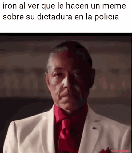 Iron Al Ver Que Le Hacen Un Meme Sobre Su Dictadura En La Policia Is Written Above A Man In A White Suit And Red Tie GIF