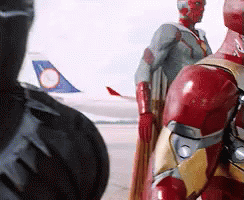 Iron Man And Black Panther Are Standing Next To Each Other In Front Of An Airplane GIF