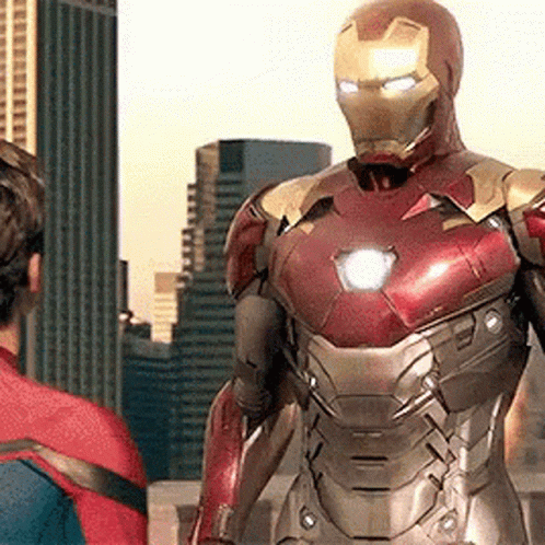Iron Man Is Standing Next To A Man In A Spiderman Suit . GIF