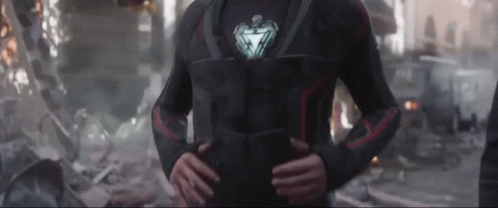 Iron Man Standing in Destroyed City Hands on Hips