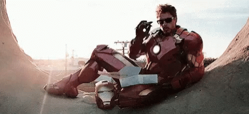 Iron Man Suit Man Next to Man in Black Jacket