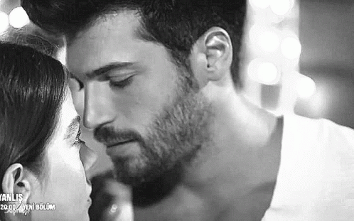 It Is A Black And White Photo Of A Man And Woman Kissing . GIF