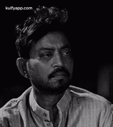 It Is A Black And White Photo Of A Man With A Beard . GIF