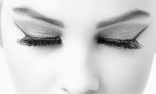 It Is A Black And White Photo Of A Woman 'S Eyes With Long Eyelashes . GIF
