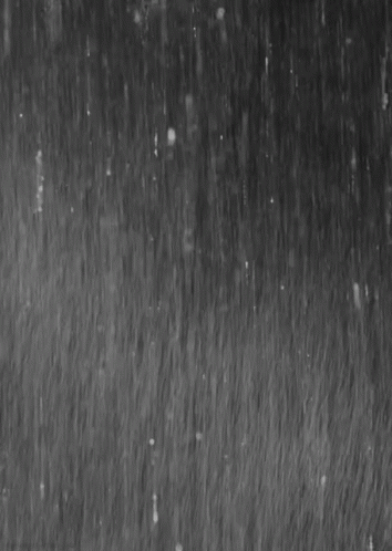 It Is A Black And White Photo Of Rain Falling On A Surface . GIF