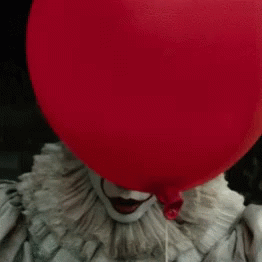 It Scary Face And Smile Behind The Balloon GIF