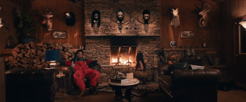 J Cole Sitting Near Fireplace GIF