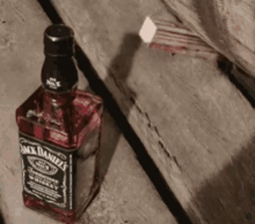 Jack Daniel's Bottle On Wooden Table GIF