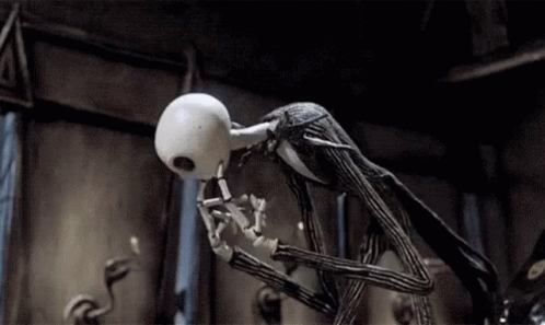 Jack Skellington From The Nightmare Before Christmas Is Standing In A Dark Room With His Mouth Open . GIF