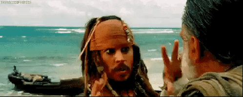 Jack Sparrow From Pirates Of The Caribbean Is Talking To A Man On A Beach . GIF
