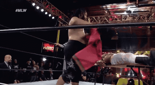 Jacob Fatu Body Slamming Opponent On Table GIF