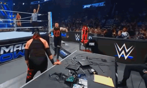 Jacob Fatu Tossing Kevin Owens Onto Table GIF