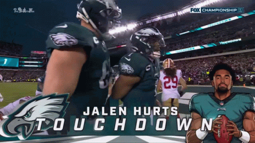 Jalen Hurts Holding Football In Front Of Fox Championship Banner GIF