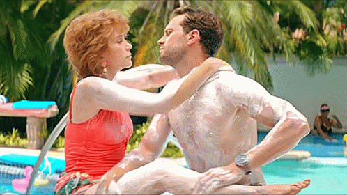 Jamie Dornan And Kristen Wiig Rubbing Lotion GIF