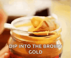 Jar Of Peanut Butter With Spoon Dip Into The Brown Gold GIF