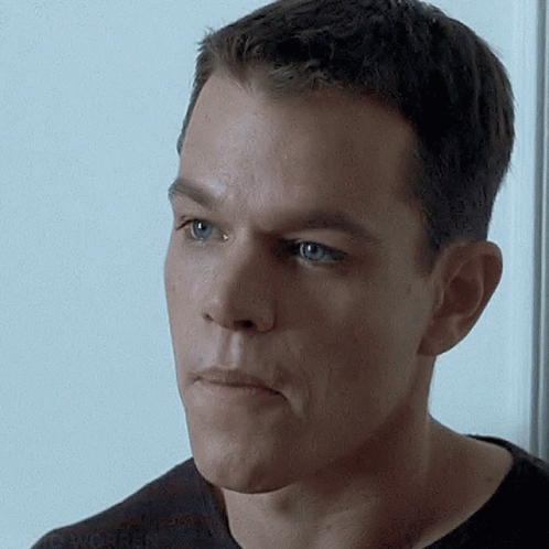 Jason Bourne Shaking His Head While Smiling GIF