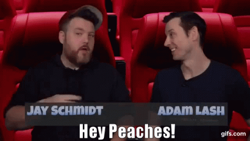 Jay Schmidt And Adam Lash Are Sitting In Red Seats Talking To Each Other GIF