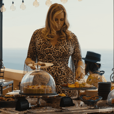Jennifer Coolidge Getting Food From Table GIF
