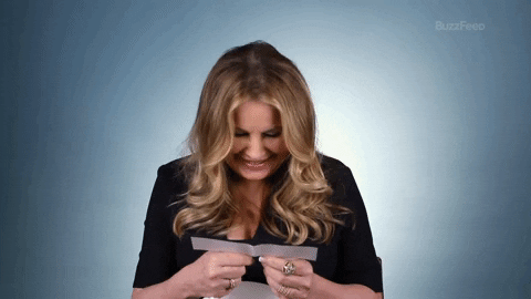 Jennifer Coolidge Laughing While Reading Messages GIF