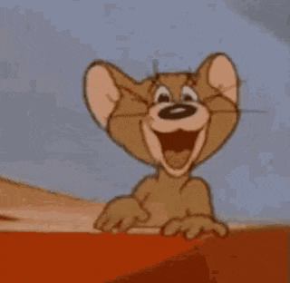 jerry from tom and jerry is smiling and pointing his finger .
