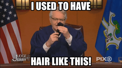 Jerry Springer Holding Hair GIF