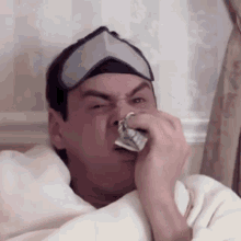 Jim Carrey Sneezing In Cash GIF