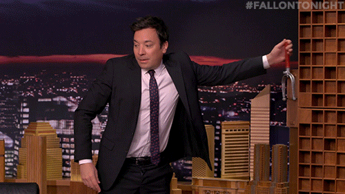 Jimmy Fallon Pushing Dominos Falling GIF