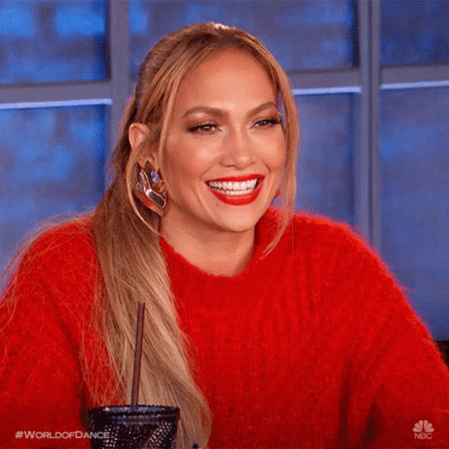 Smiling Jlo In Red Sweater GIF