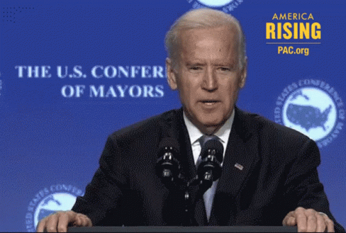Joe Biden at Podium with U.S. Confer of Mayors Sign