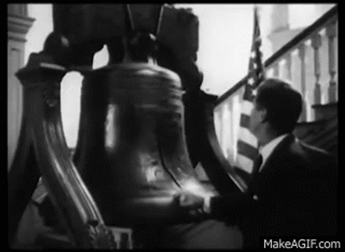 John F. Kennedy Touching Old Bell GIF