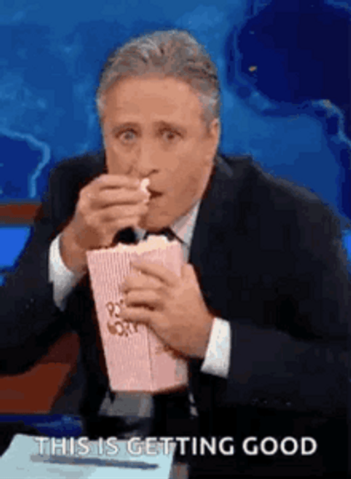 Jon Stewart Cramming Down Popcorn Meme GIF