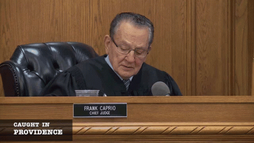 Judge in Robe Sitting at Desk