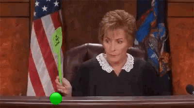 Judge Playing with Green Tennis Ball at Bench