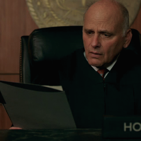 Judge Sitting at Desk with HC Name Plate