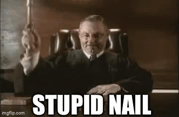 Judge Sitting at Desk with Stupid Nail