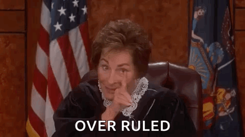 Judge Sitting in Court with Hand on Face