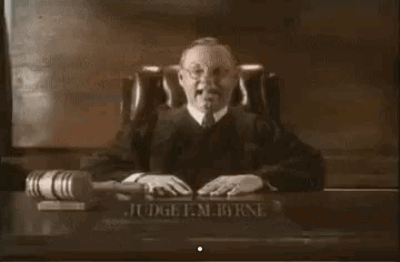 Judge Smiling at Desk