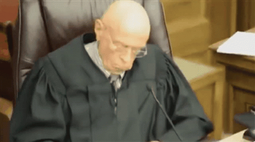 Judge With Glasses In Courtroom GIF