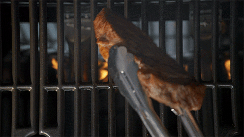 Juicy Meat Steak Flipping Over Flaming Charcoals GIF