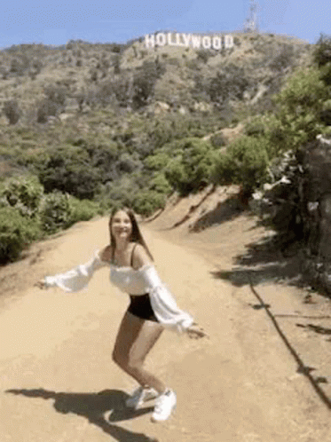 A Girl In The Mountains Jumping For Joy GIF