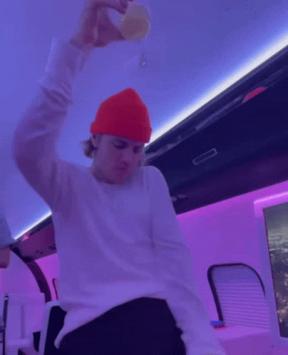 Justin Bieber In His White Sweater And Orange Bonnet GIF
