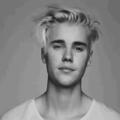 Justin Bieber In His Messy Hair And Winking GIF