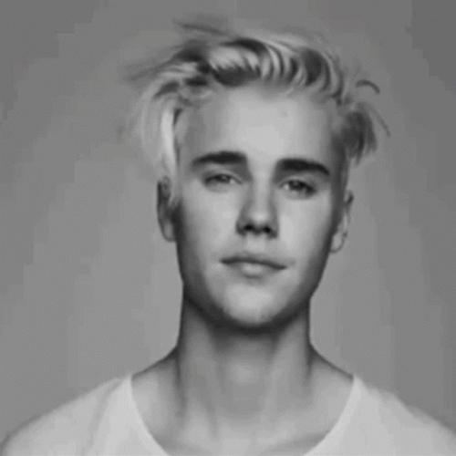 Justin Bieber In His Messy Hair And Winking GIF