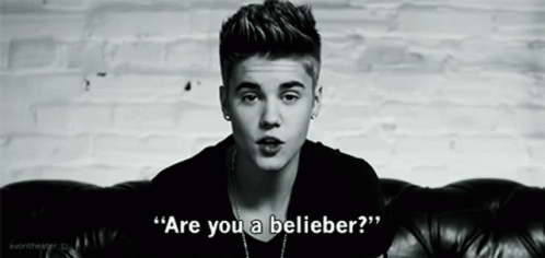 Justin Bieber Is Sitting On A Couch In A Black And White Photo And Says `` Are You A Believer ? '' GIF